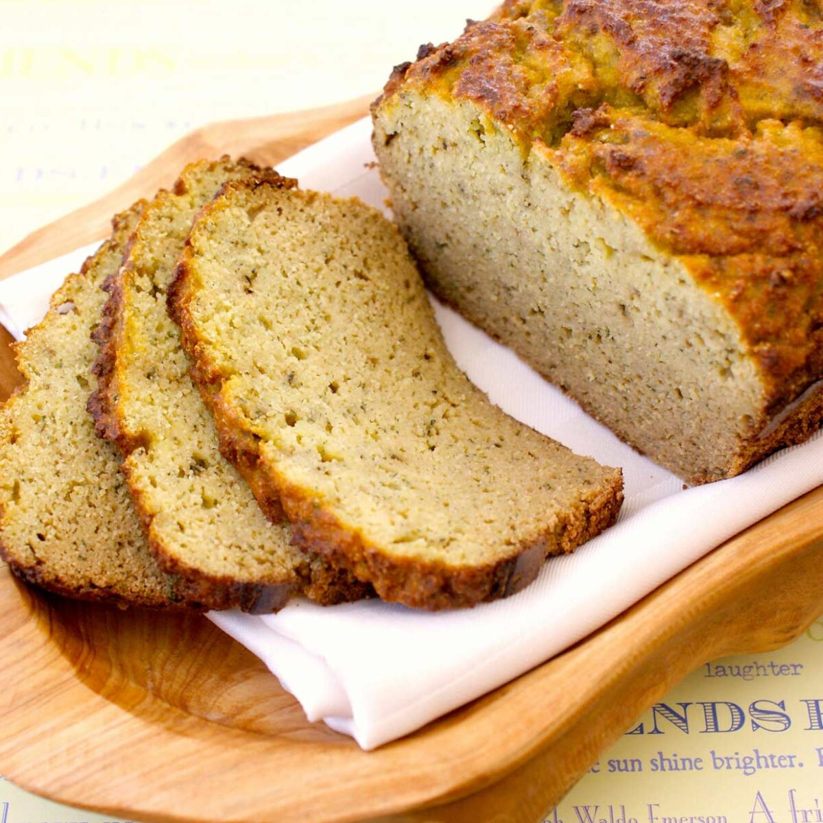 sliced zucchini bread on wood serving tray