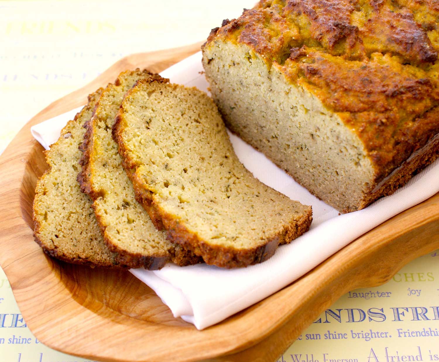 sliced zucchini bread on wood serving tray